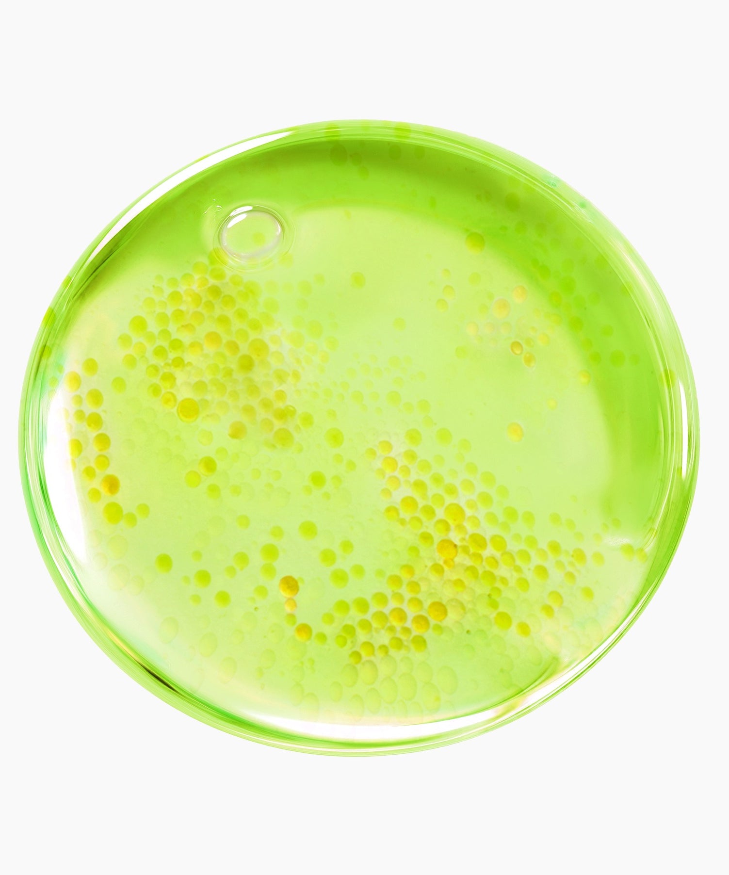 Texture du PURITO Azelaic Acid 10 Kojic Tea Tree Serum 30ml avec bulles jaunes dans un liquide vert translucide.