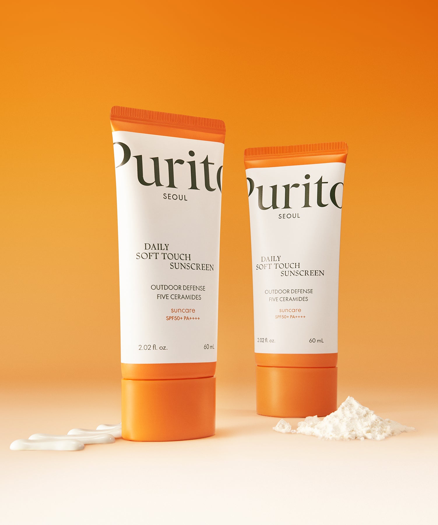 Crème solaire PURITO Daily Soft Touch Sun Cream SPF50+PA++++ sur fond orange.
