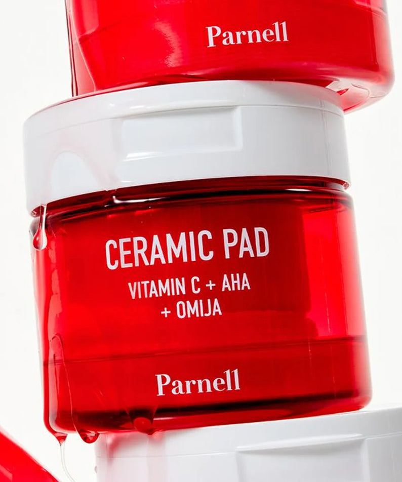 PARNELL  AHA Omija Ceramic Pad 60 Pads, flacon rouge Parnell sur fond blanc, pack « Ceramic Pad + Omija ».