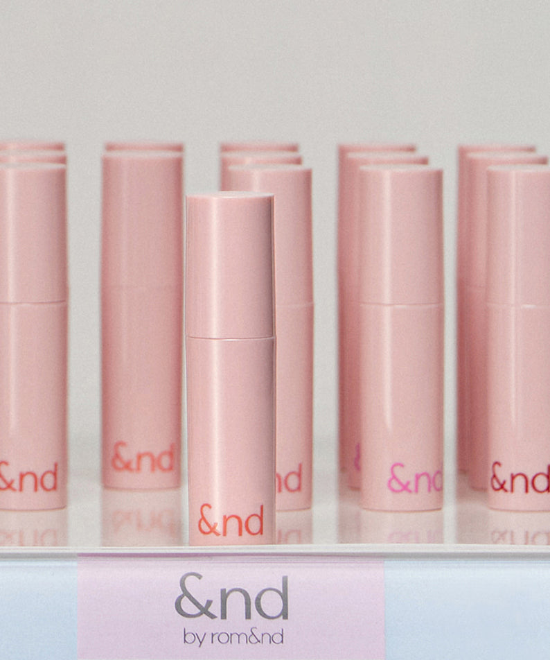 ROMAND  Glassy Bomb Tint de &nd par romanda, présentation maquillage rose en tubes alignés sur fond clair