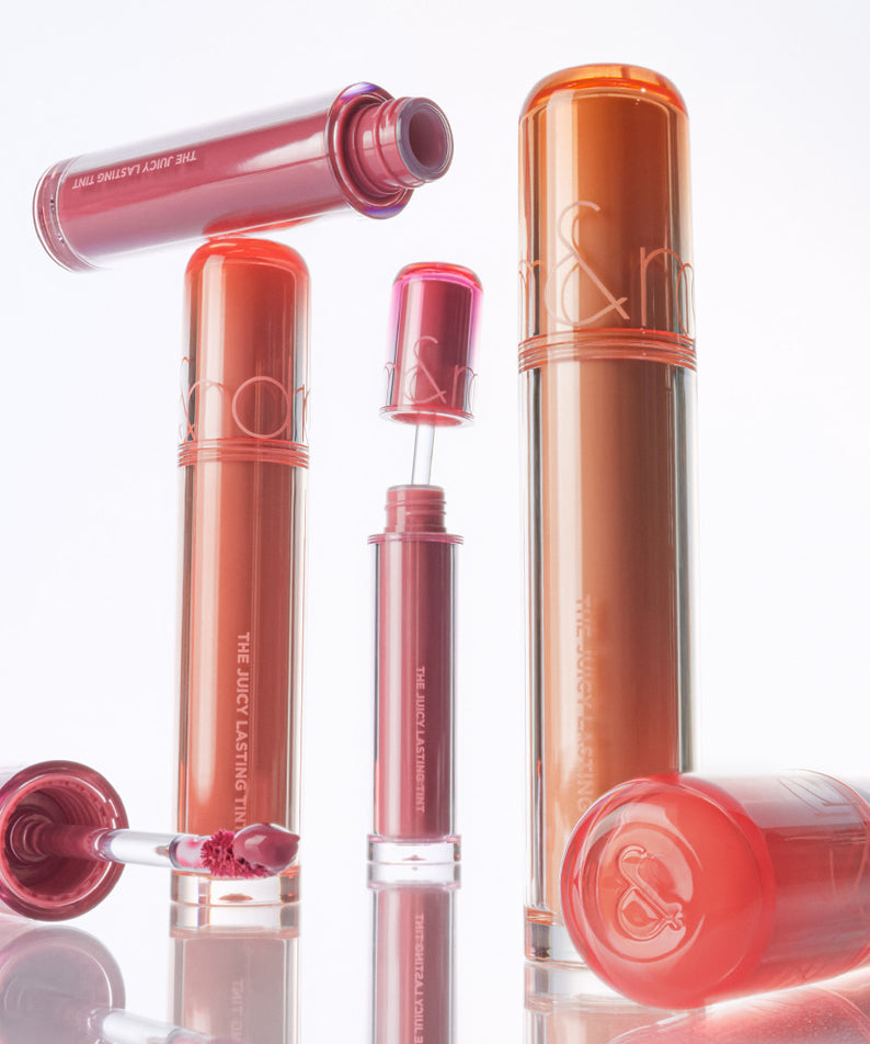 Collection de teintes de ROMAND The Juicy Lasting Tint avec plusieurs rouges à lèvres liquides en arrière-plan, emballage élégant.