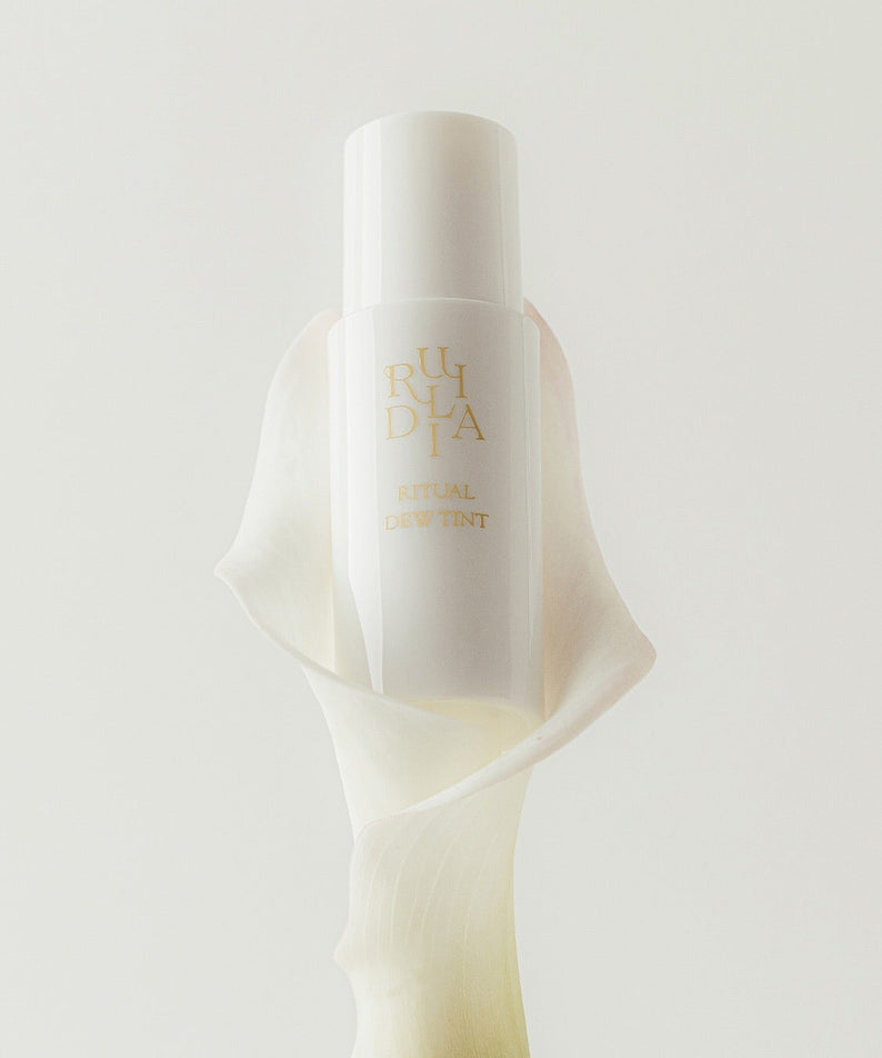 RULIDIA Ritual Dew Tint de la marque RULIDIA, flacon illuminé sur fond crème, mise en scène minimaliste.