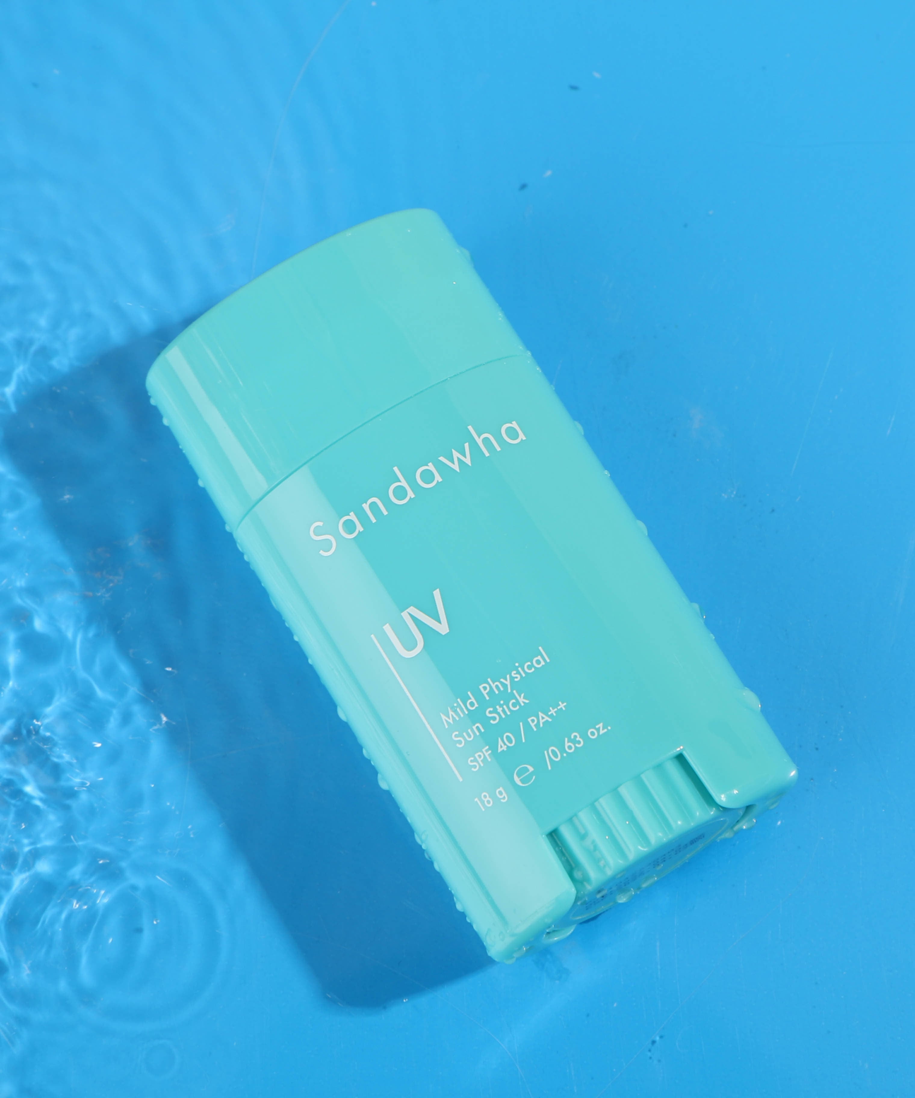 SANDAWHA Mild Mineral Sunscreen Stick SPF40 PA++ 18g, sur fond bleu évoquant des eaux, bâton solaire de la marque.