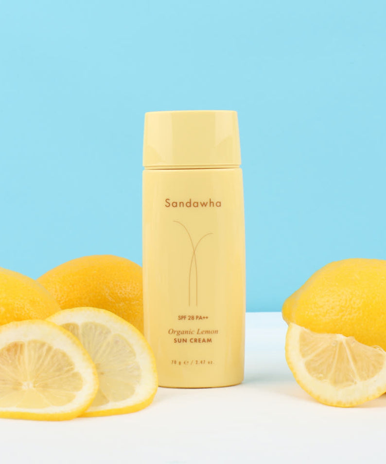 SANDAWHA Organic Lemon Sunscreen 70g, crème solaire bio au citron sur fond bleu avec citrons, marque sur le flacon.