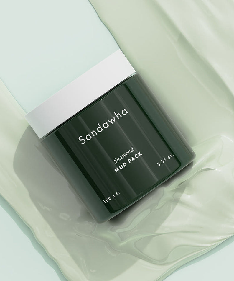 SANDAWHA Seaweed Mud Pack 100g : pack de boue algues dans un pot noir sur fond crème, marque visible.
