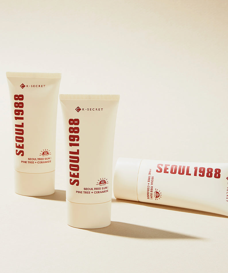 Crème solaire SEOUL 1988 Pine Sunscreen avec protection SPF, tubes de crème sur fond beige, idéal pour la peau sensible.