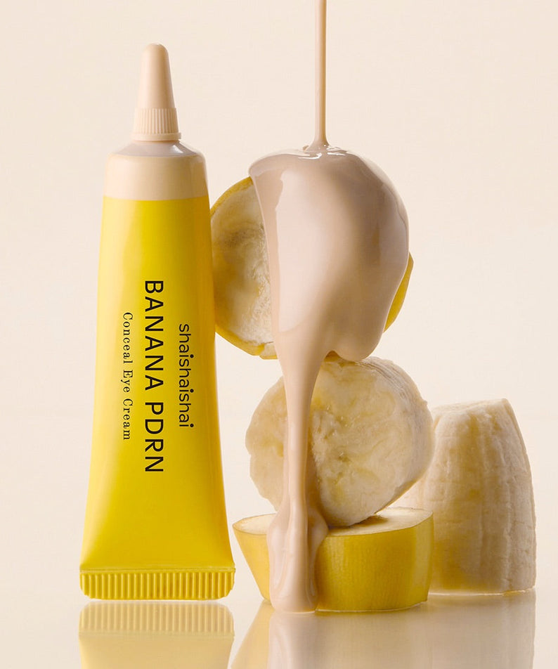 SHAISHAISHAI Banana PDRN Conceal Eye Cream 15ml : tube jaune sur fond crème, contexte beauté, marque SHAISHAISHAI.