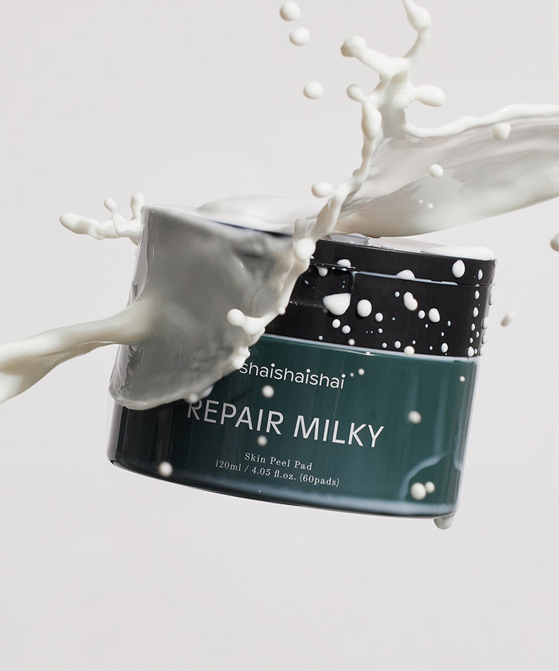 SHAISHAISHAI Repair Milky Skin Peel Pad 60 Pads 120ml, marque en flacon noir, lait/pulpe blanche éclaboussures sur fond clair.