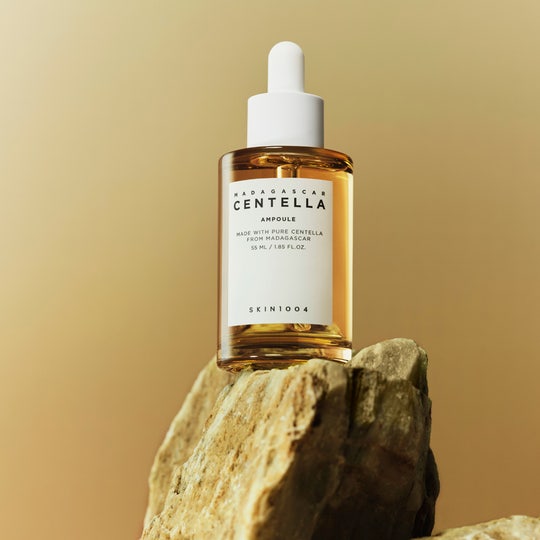 SKIN1004 Madagascar Centella Ampoule 55ml, marque SKIN1004, flacon sérum sur pierre, fond beige, contexte beauté.