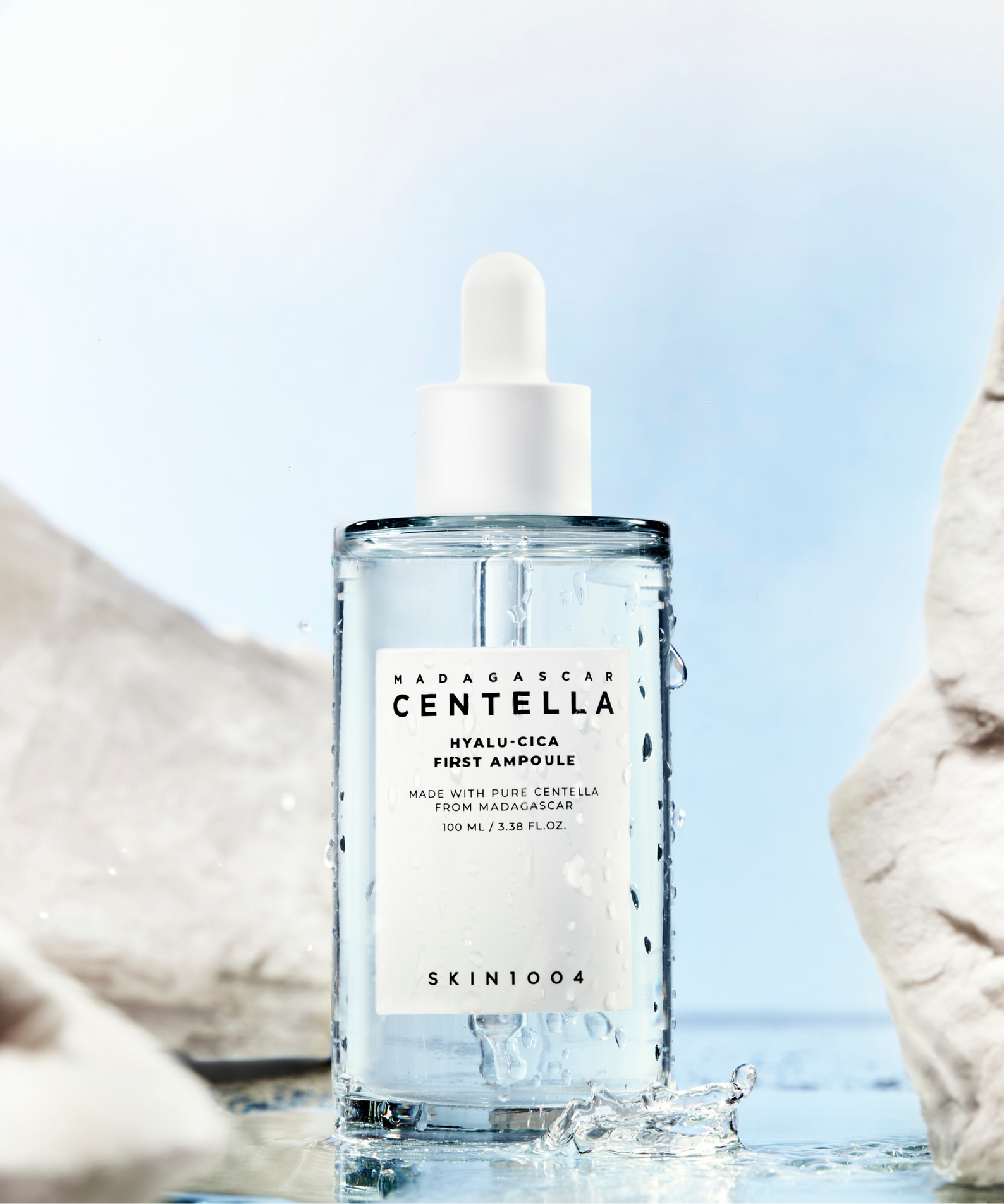 SKIN1004 Madagascar Centella Hyalu-Cica First Ampoule 100ml de SKIN1004, flacon sur fond plage avec rochers et eau