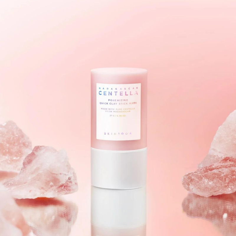 SKIN1004 Madagascar Centella Poremizing Quick Clay Stick Mask 27g, marque SKIN1004, stick sur fond rose avec cristaux.