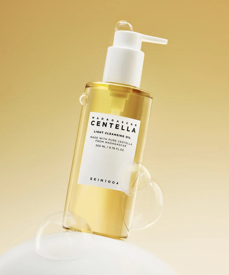 SKIN1004 Madagascar Centella Light Cleansing Oil 200ml sur fond jaune, huile nettoyante légère avec pompe blanche.