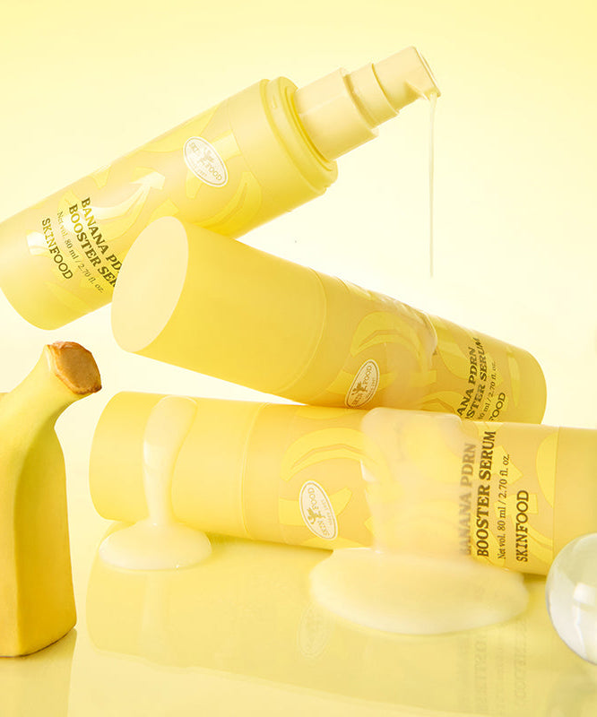 SKINFOOD Banana PDRN Booster Serum 80ml de la marque SKINFOOD, flacons jaunes sur fond crème, contexte beauté soin