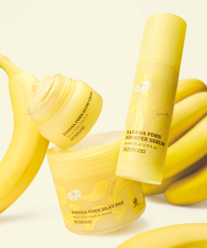 SKINFOOD Banana PDRN Booster Serum 80ml, marque SKINFOOD, flacon jaune près de bananes sur fond clair.