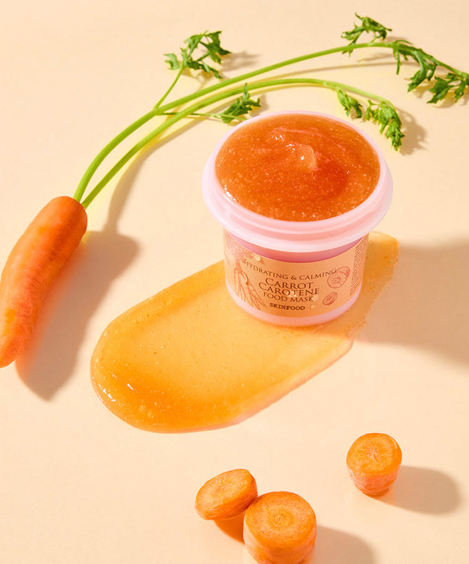 SKINFOOD [NEW ] Carrot Food Mask 120g, masque visage à la carotte sur fond beige avec carottes et pot produit.