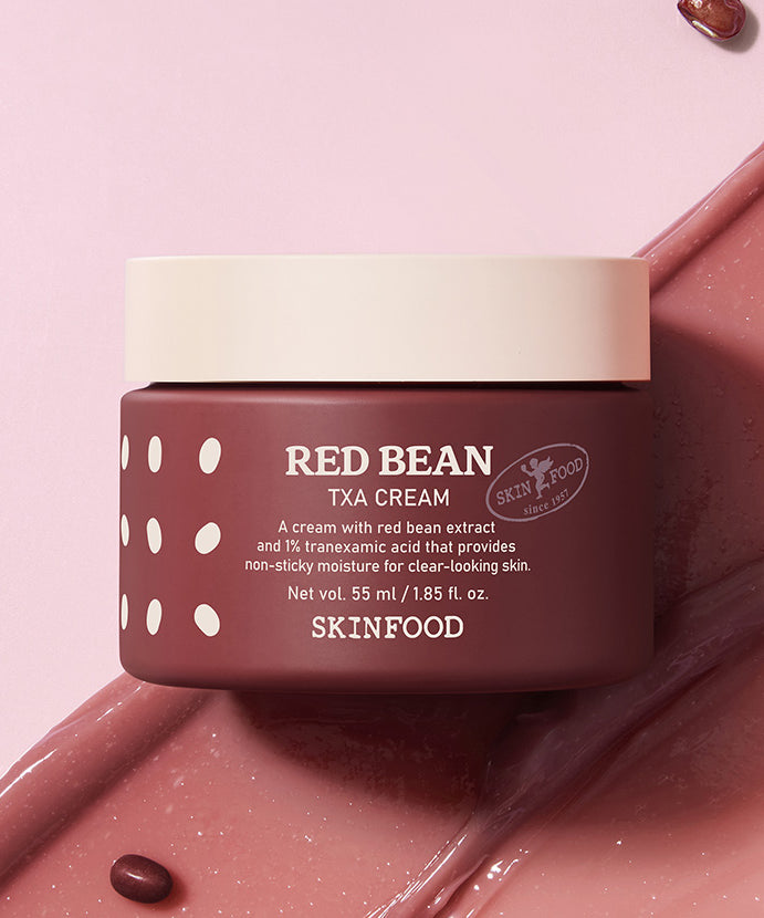 SKINFOOD Red Bean Tranexamic Acid Cream 55ml de la marque SKINFOOD, pot sur fond rose, crème rouge et gouttes