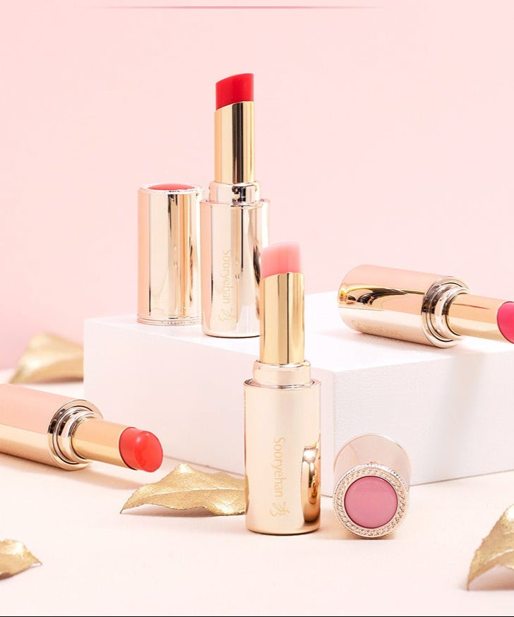 SOORYEHAN Yeon Silk Lip Balm 3.5g, marque SOORYEHAN : stick et baume sur fond rose, capsules dorées et reflets glam.