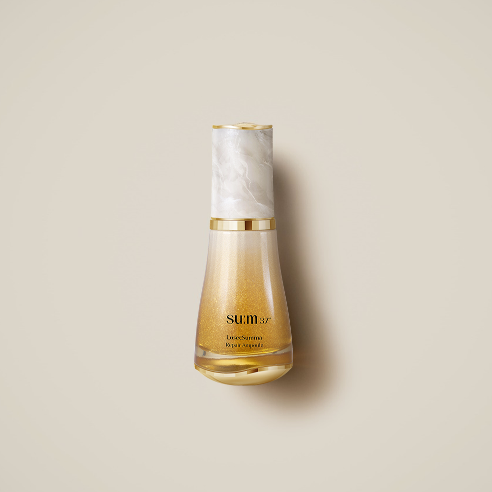 SU:M37 LosecSumma Repair Ampoule 50ml, flacon doré sur fond beige, marque SU:M37 visible, produit cosmétique.