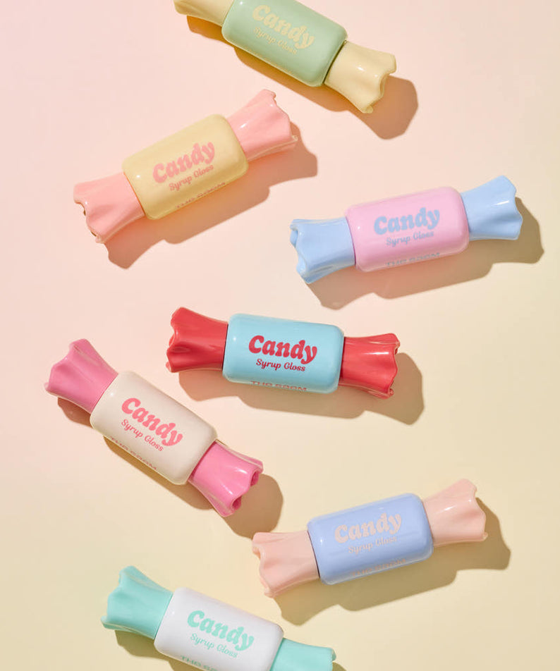 THE SAEM Saemmul Candy Syrup Gloss, gommage brillant en tubes pastel sur fond beige, marque THE SAEM, visuel candy