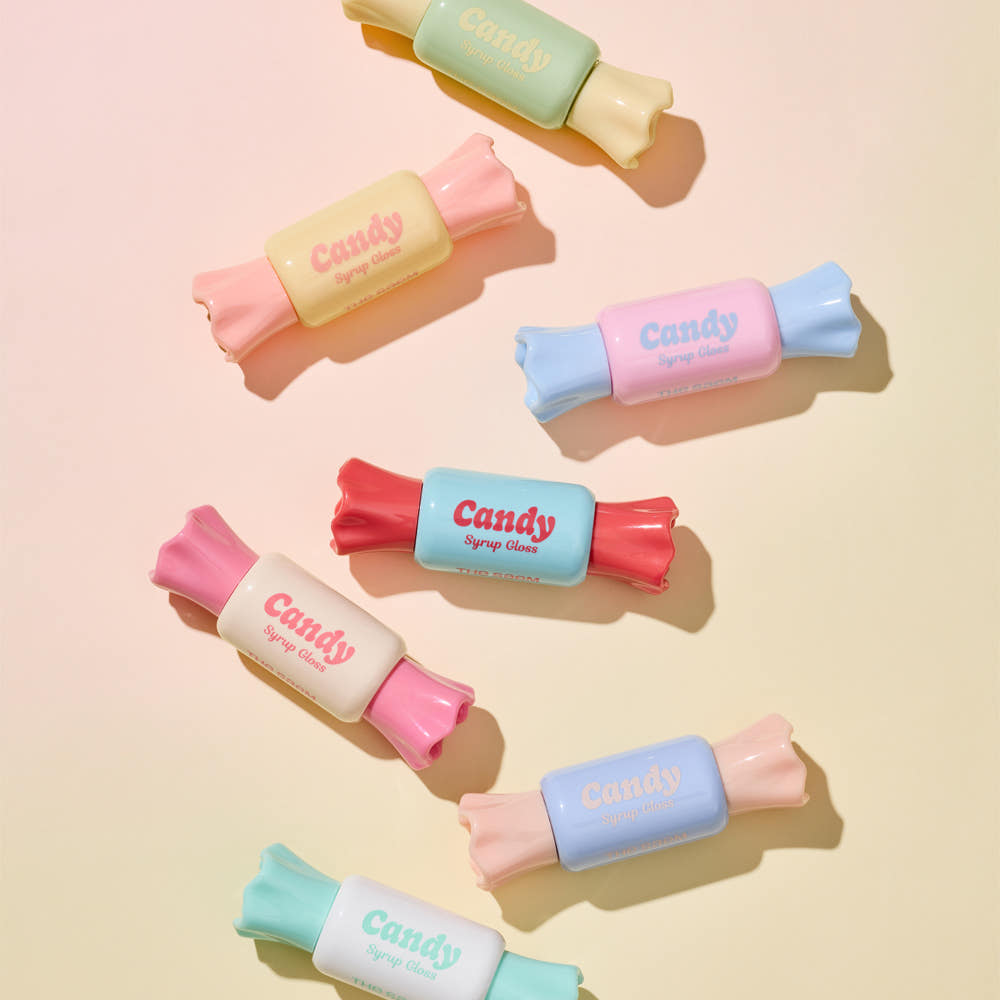 THE SAEM Saemmul Candy Syrup Gloss, gommage brillant en tubes pastel sur fond beige, marque THE SAEM, visuel candy