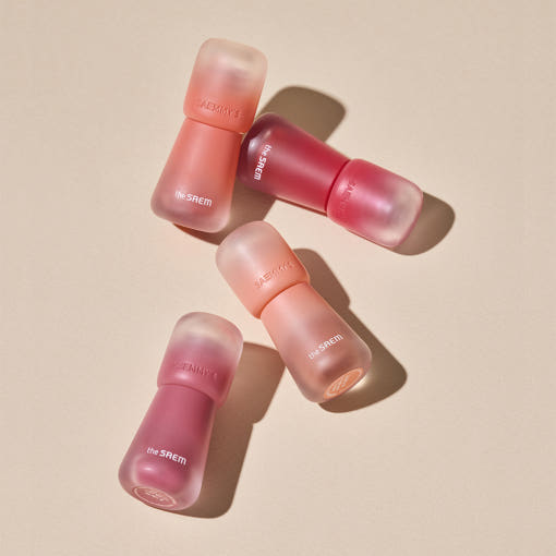 THE SAEM Saemmy's Crema Velvet Tint, la marque THE SAEM, en tubes colorés sur fond beige, rendu crème velours.