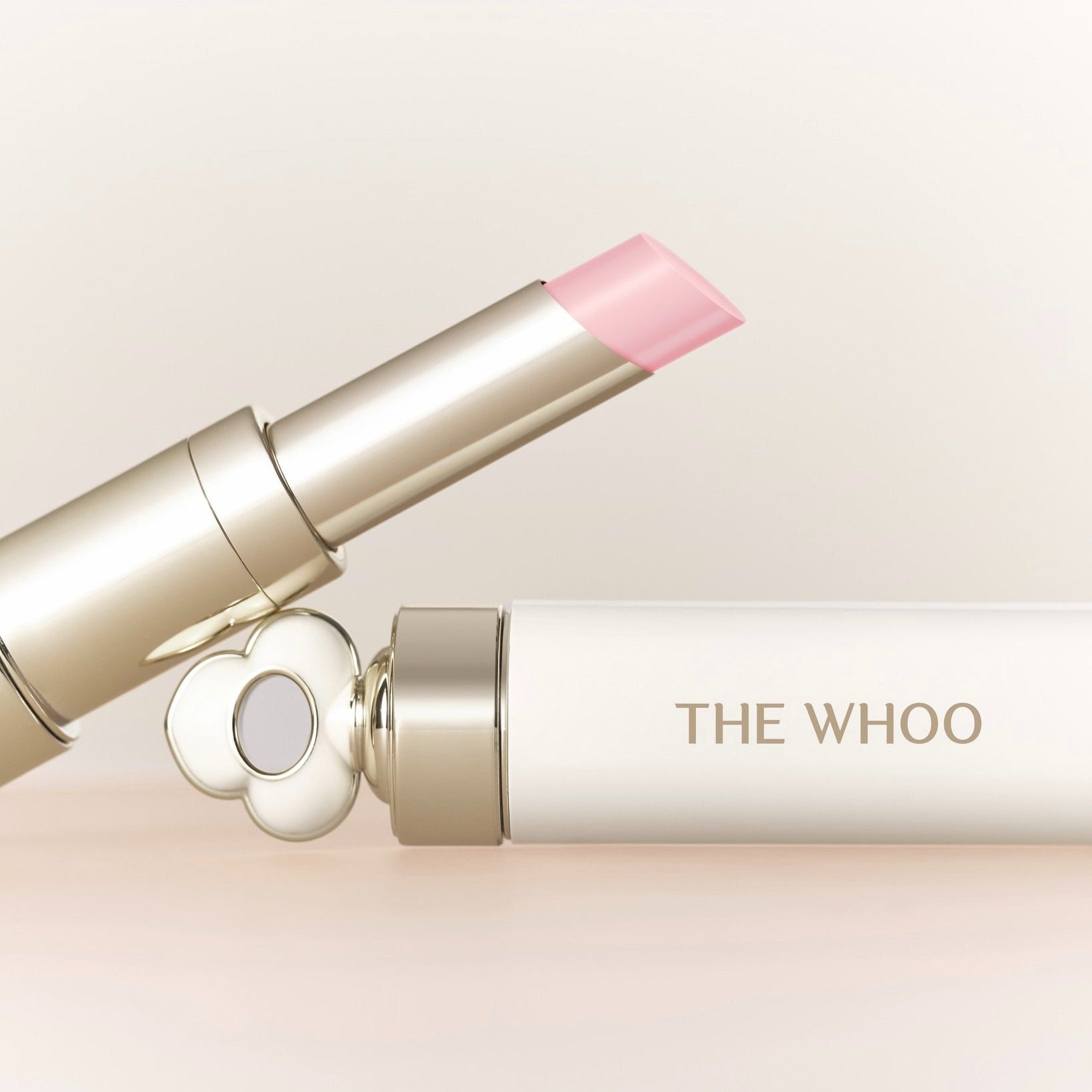 THE WHOO Essentail Lip Glow Balm, baume à lèvres rose sur fond clair, packaging élégant de la marque THE WHOO.