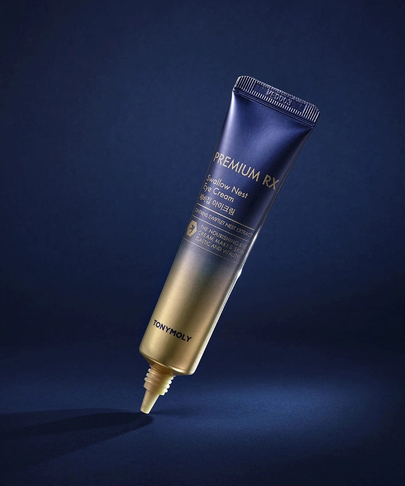 Décris l'image en français : TONY MOLY Premium RX Swallow's Nest Eye Cream sur fond bleu nuit, flacon tube visible.