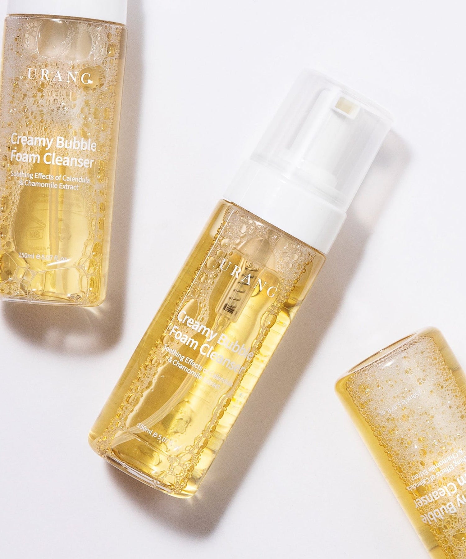 Trois bouteilles de URANG Creamy Bubble Foam Cleanser 150ml sur fond blanc.