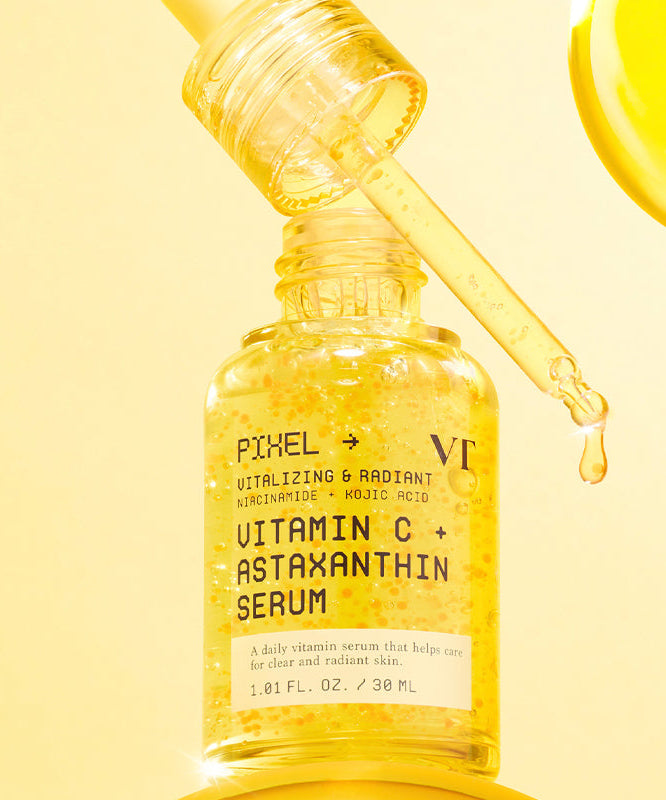 Décris l'image en français : VT COSMETIC Vitamin C Astaxanthin Serum 30ml, flacon jaune sur fond lumineux, gouttelette