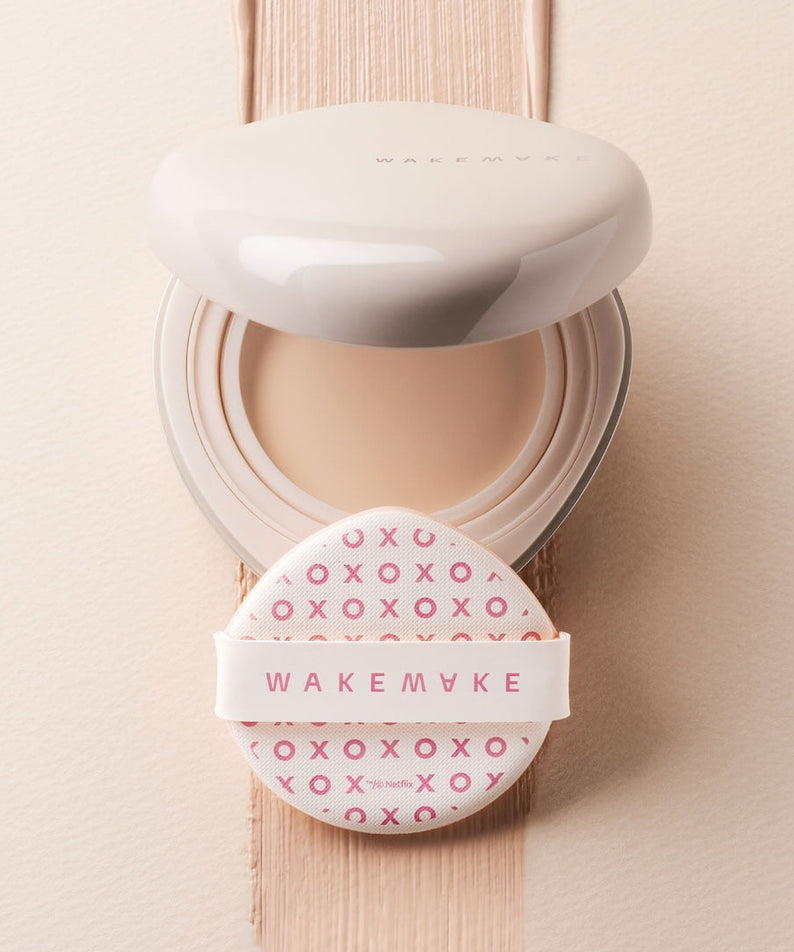 WAKE MAKE Water Glow Coating Balm 12.5g en boîte élégante avec applicateur rose en fond crème, hydratation et éclat garanti.