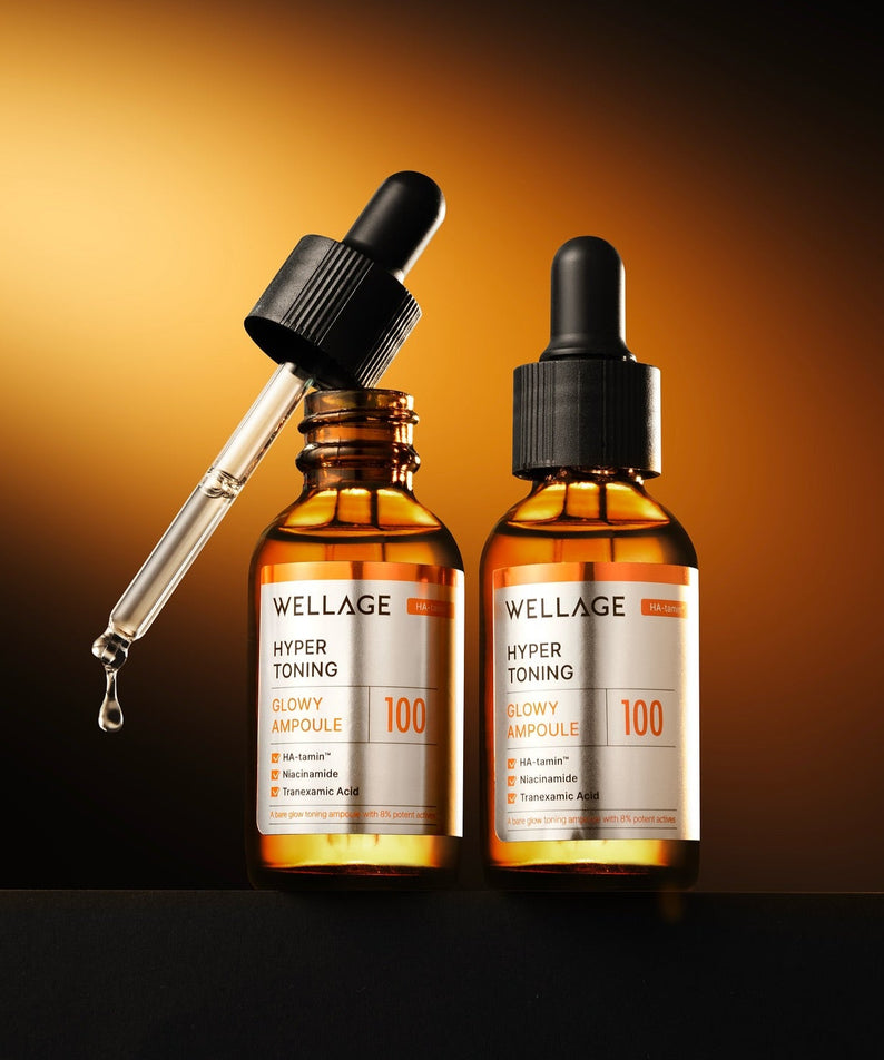 WELLAGE Hyper Toning Glow Ampoule 30ml, marque WELLAGE, sérum en flacons avec goutteur sur fond orange en studio.