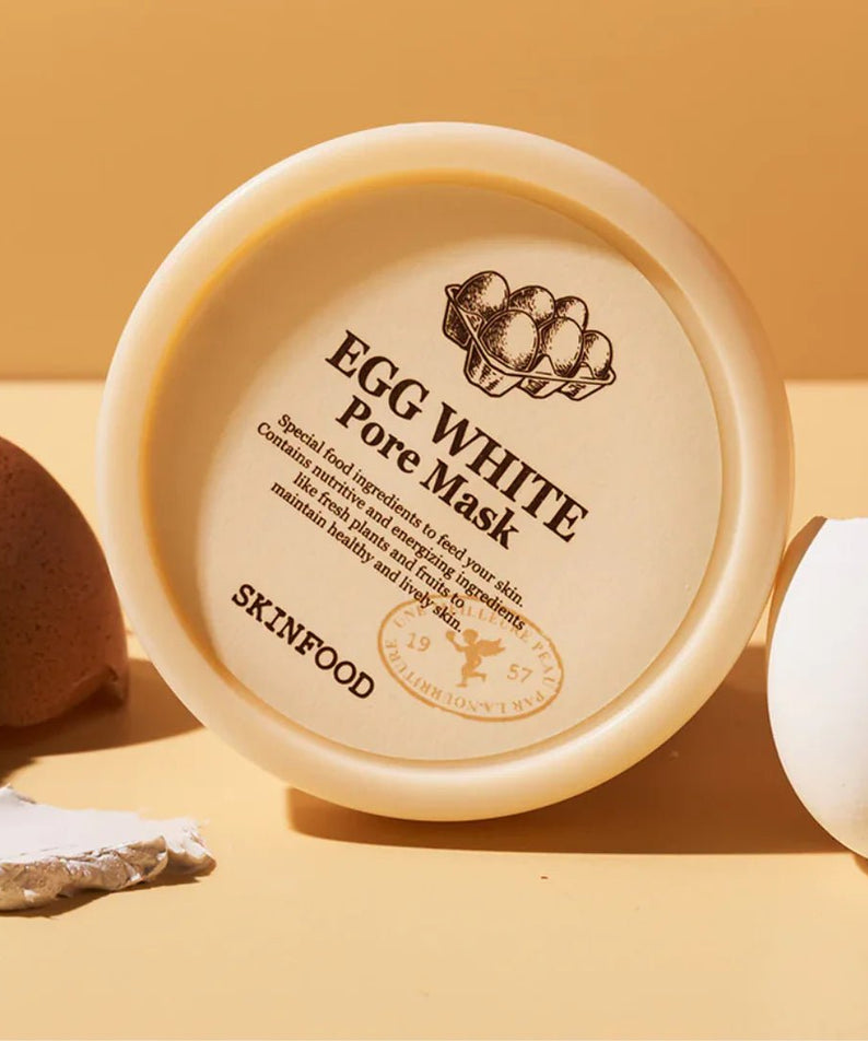 SKINFOOD Egg White Pore Mask 120g, pot crème sur fond orange avec œuf et ingrédients, marque SKINFOOD en gros plan